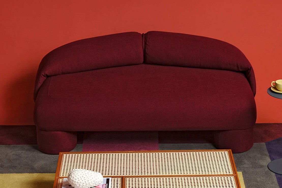 Bold Sofa in burgundy against a red wall
