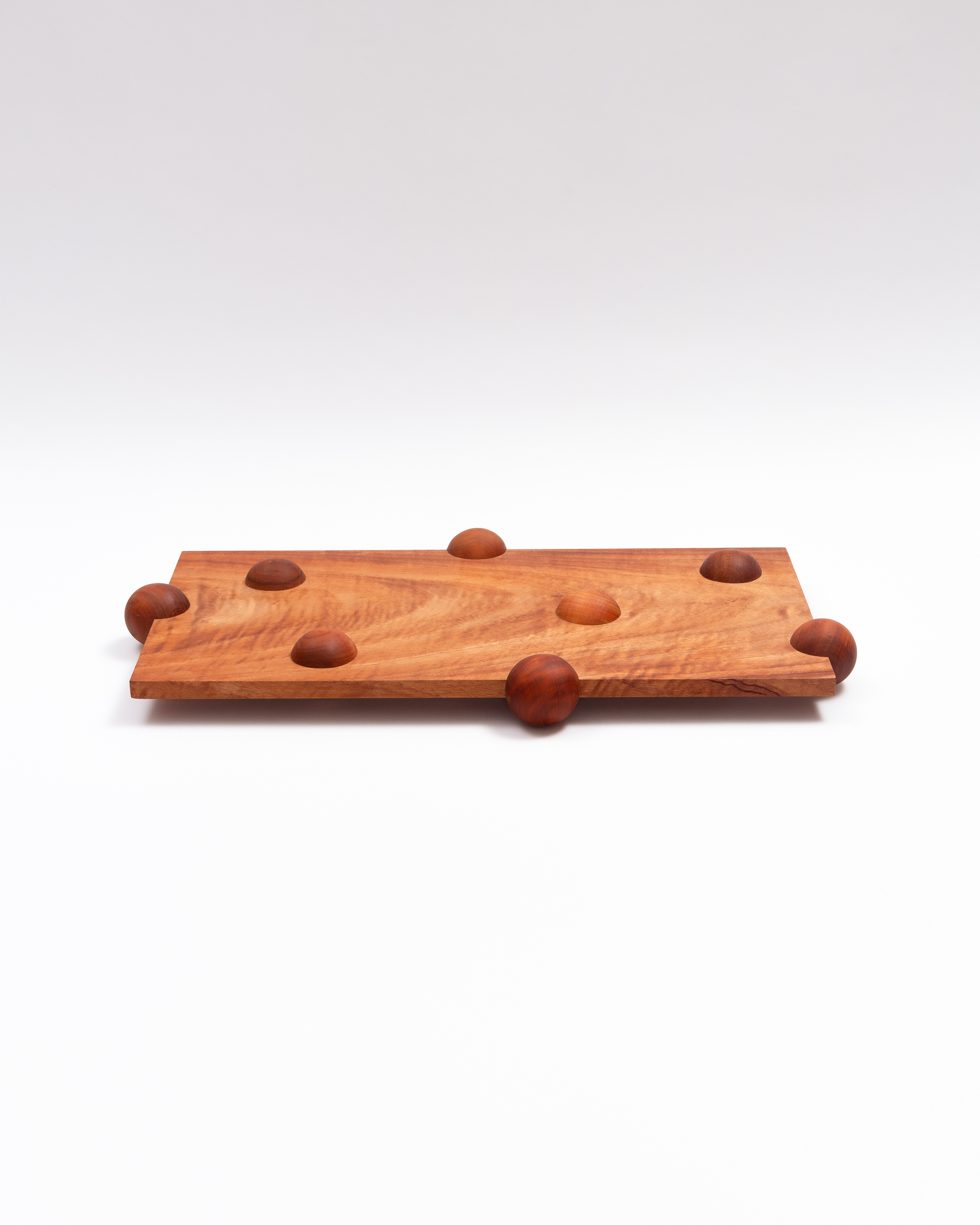 Long board seen from the side on its rounded feet