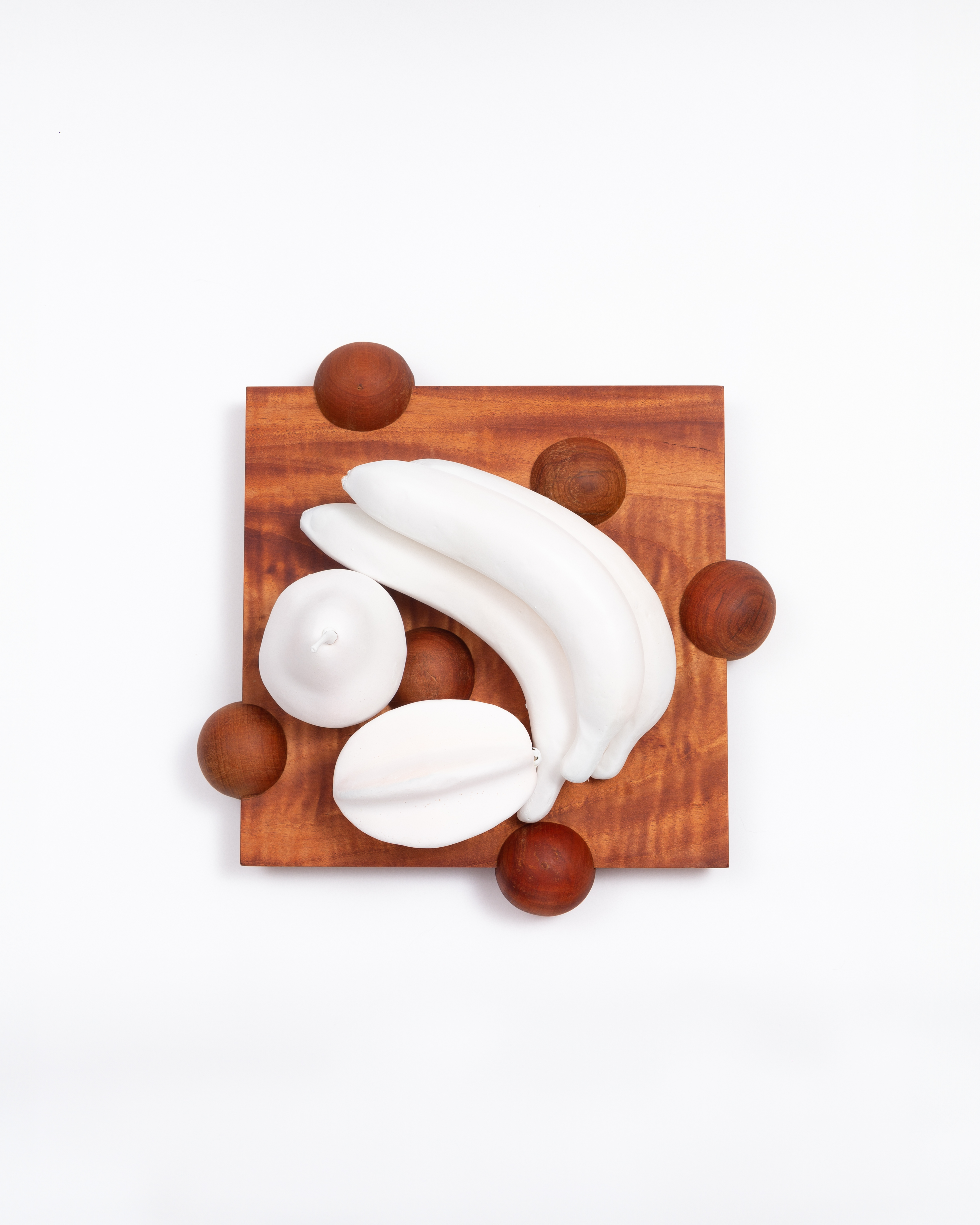 Square board styled with white bananas and fruit